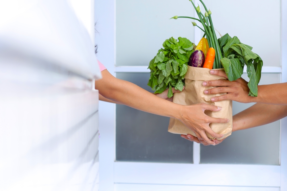 A delivery of fresh groceries handed over at the door